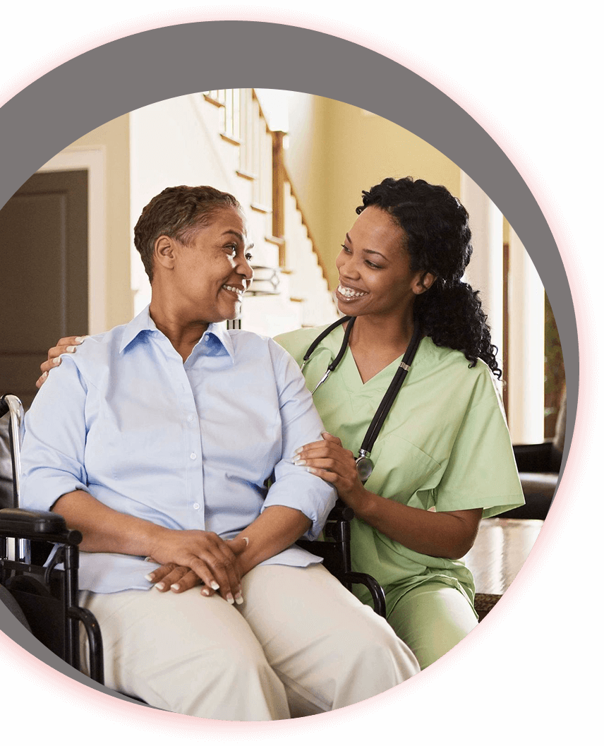 A nurse and an elderly woman in a wheelchair.